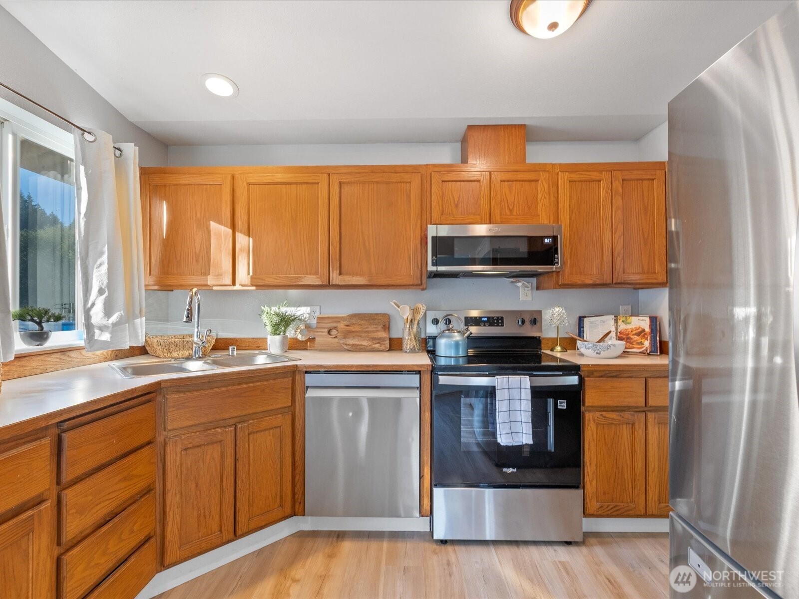 13802 State Rte 530 Northeast Arlington, WA 98223 - Photo 16 of 40 a kitchen with stainless steel appliances a stove a sink and a microwave