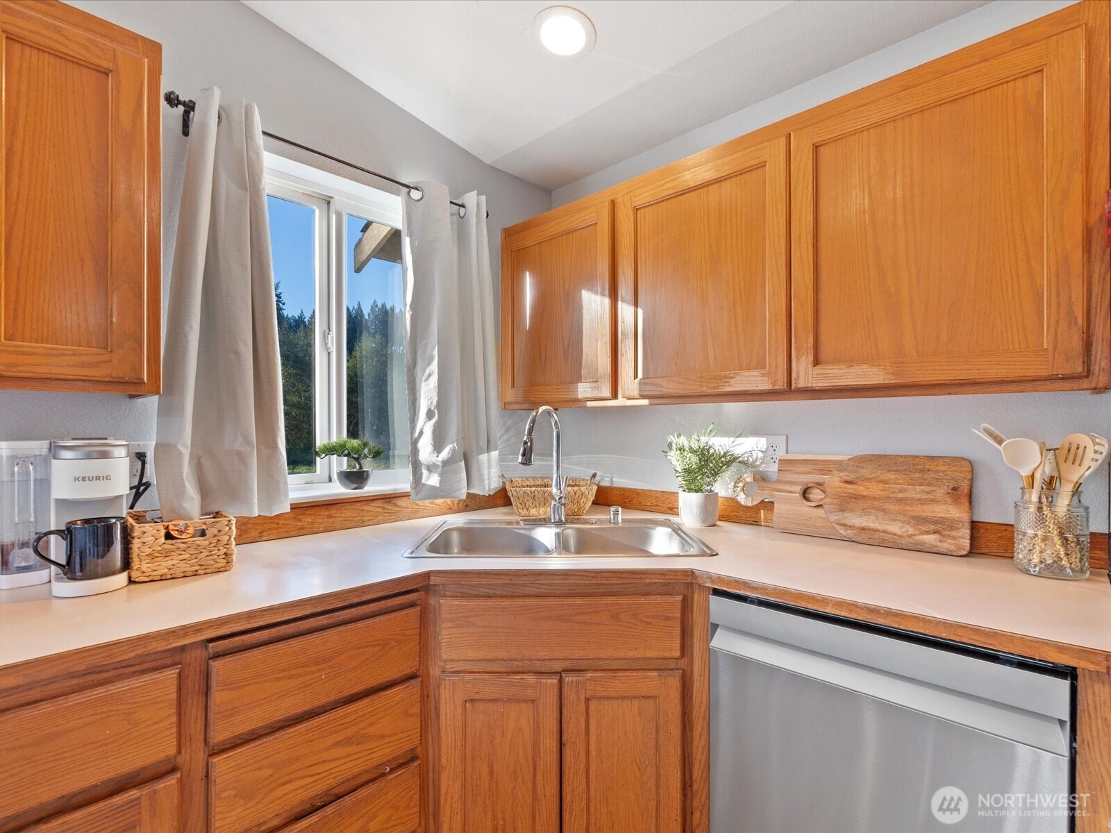 13802 State Rte 530 Northeast Arlington, WA 98223 - Photo 17 of 40 a kitchen with stainless steel appliances granite countertop a sink a refrigerator and cabinets