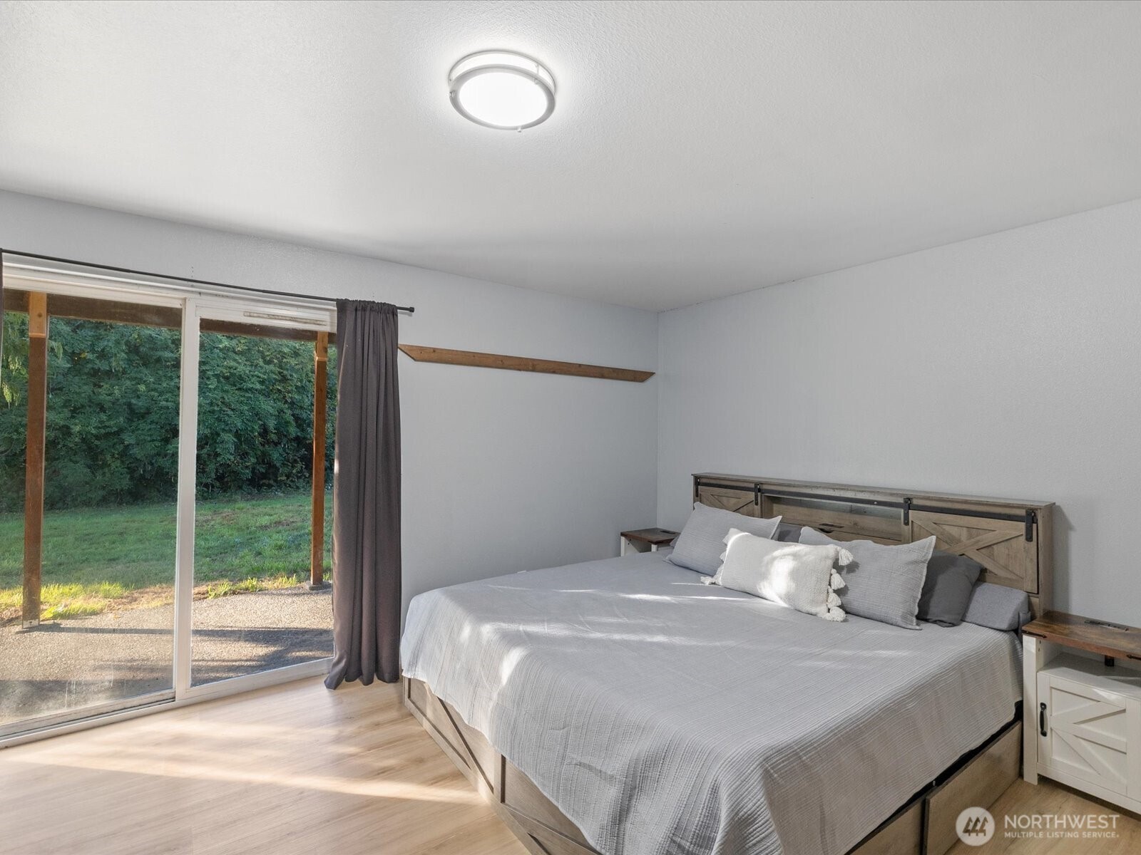 13802 State Rte 530 Northeast Arlington, WA 98223 - Photo 28 of 40 a bedroom with a large bed and a large window