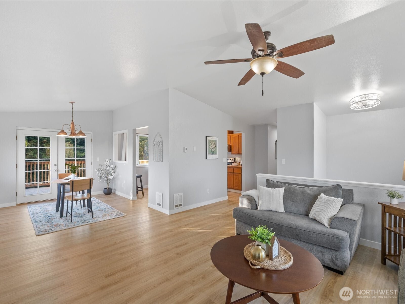 13802 State Rte 530 Northeast Arlington, WA 98223 - Photo 8 of 40 a living room with furniture kitchen view and a wooden floor
