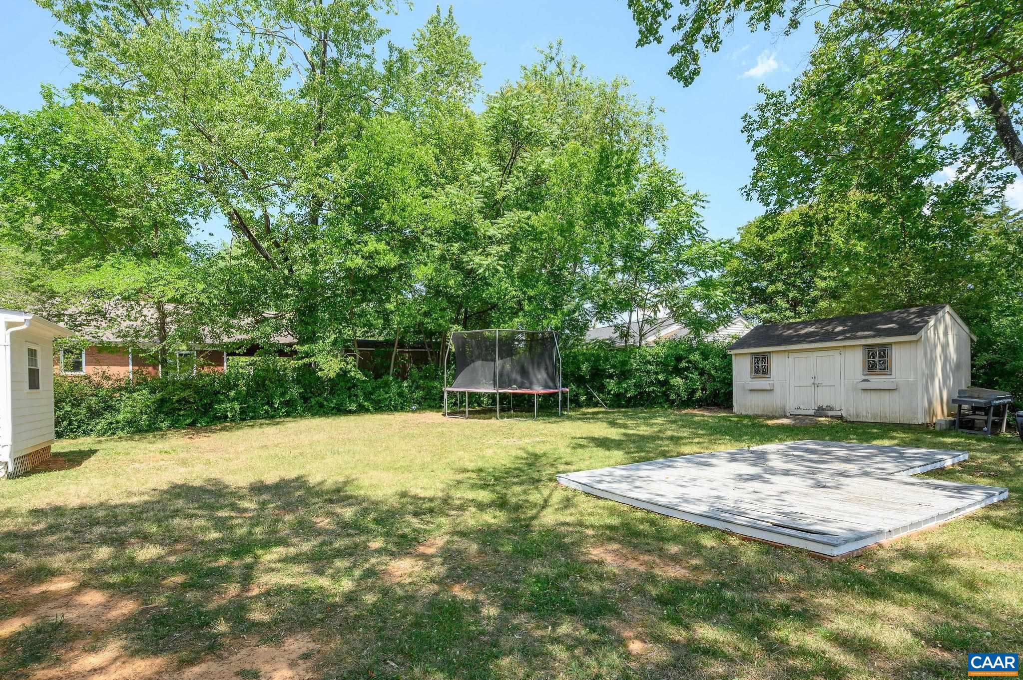 2806 Brookmere Road Charlottesville, VA 22901 - Photo 17 of 19 a backyard of a house with large trees and brick wall