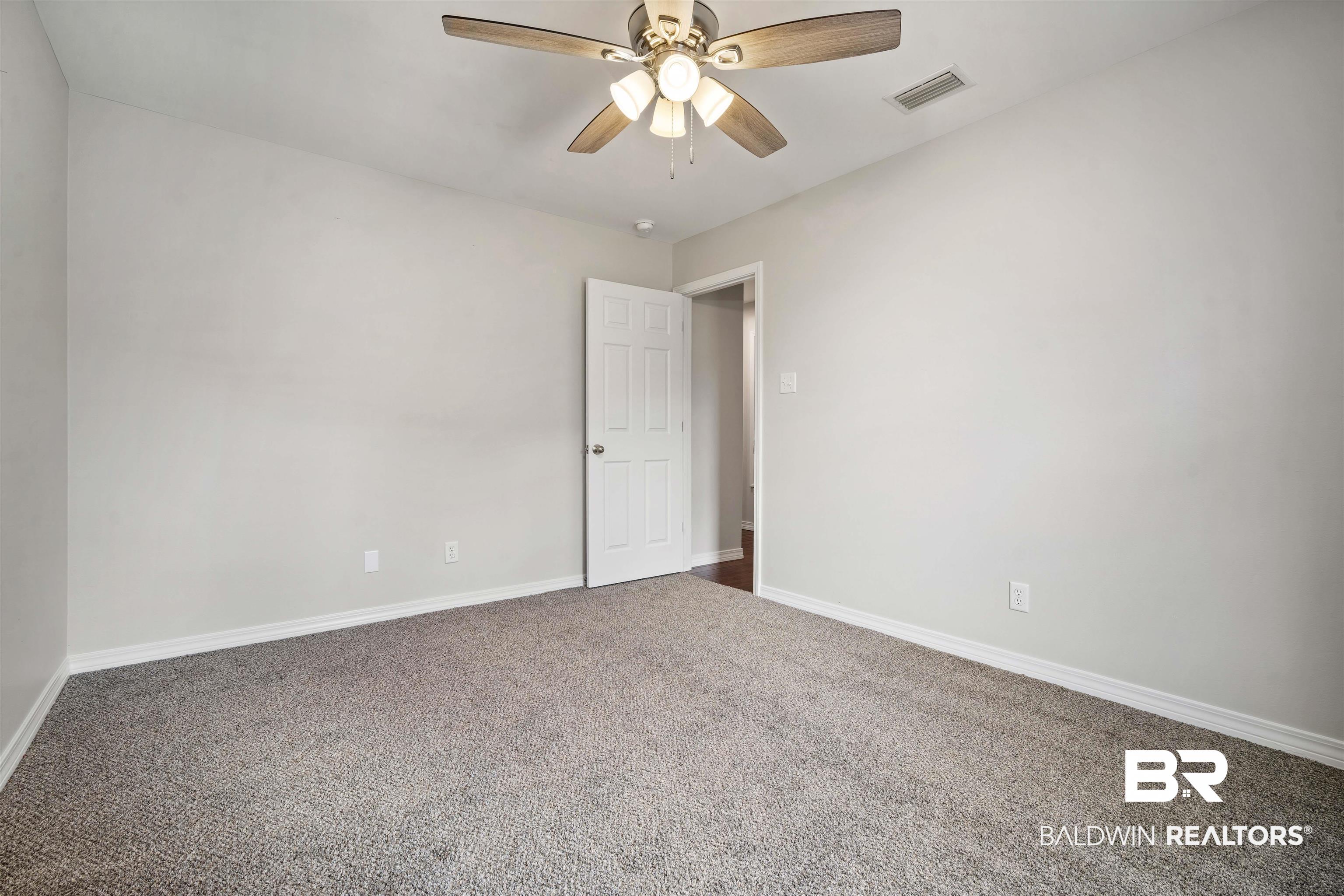 4000 Fenwick Loop Mobile, AL 36619 - Photo 26 of 31 Empty room featuring a ceiling fan and carpet flooring
