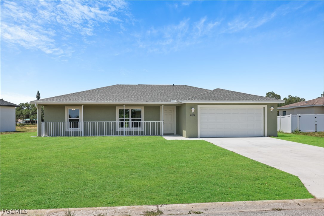 a front view of a house with yard and green space