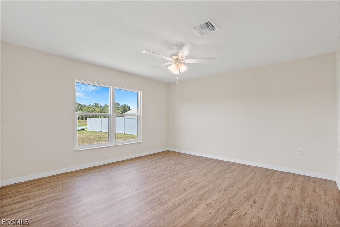 4524 Springview Circle LaBelle, FL 33935 - Photo 13 of 25 wooden floor in an empty room with a window