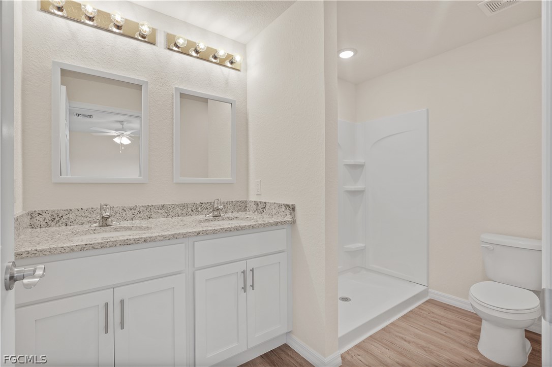 4524 Springview Circle LaBelle, FL 33935 - Photo 15 of 25 a bathroom with a granite countertop sink a toilet and shower