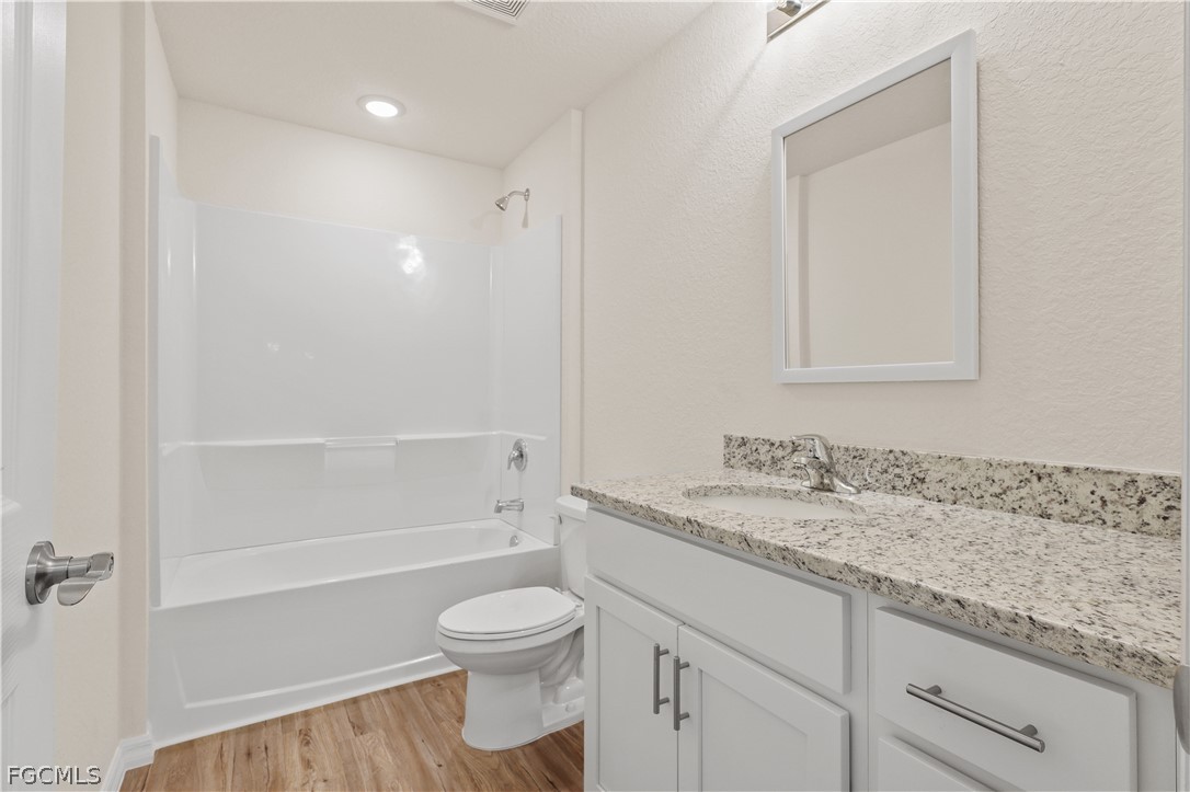4524 Springview Circle LaBelle, FL 33935 - Photo 17 of 25 a bathroom with a granite countertop sink a toilet and shower