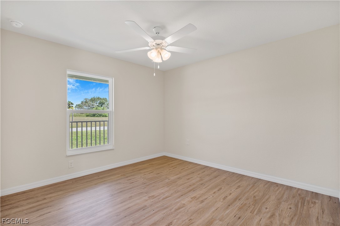 4524 Springview Circle LaBelle, FL 33935 - Photo 18 of 25 a view of an empty room with wooden floor and a window