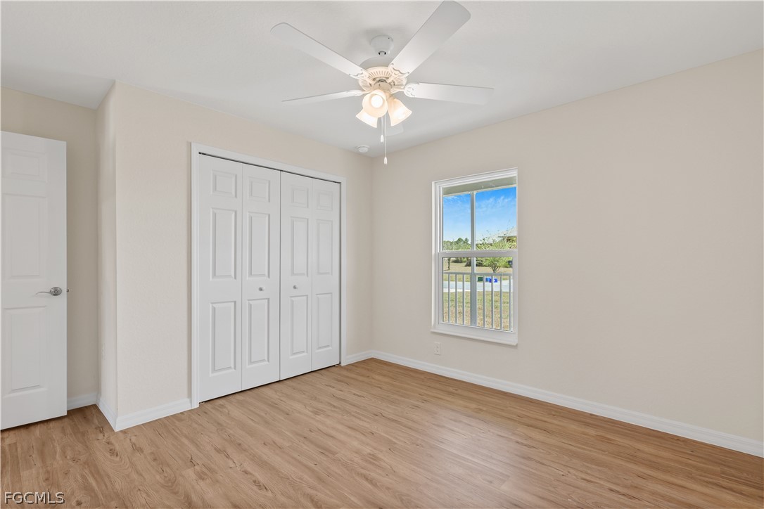 4524 Springview Circle LaBelle, FL 33935 - Photo 20 of 25 a view of an empty room with wooden floor and a window