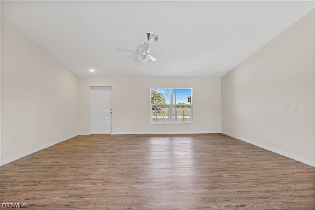 4524 Springview Circle LaBelle, FL 33935 - Photo 5 of 25 a view of an empty room with a window and wooden floor