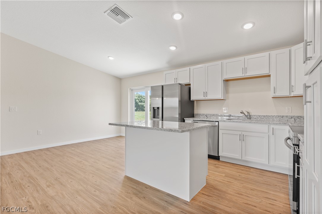 4524 Springview Circle LaBelle, FL 33935 - Photo 9 of 25 a kitchen with granite countertop white cabinets and white appliances