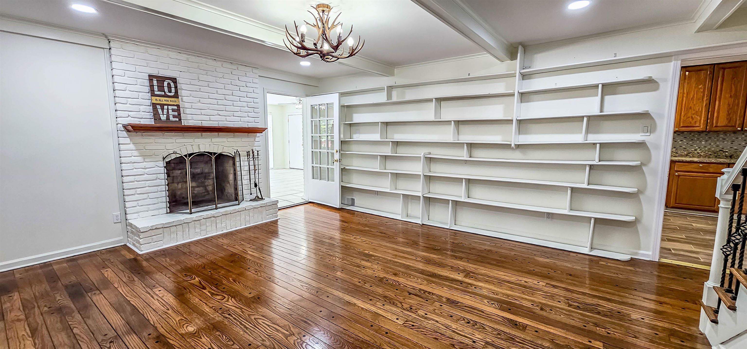 5639 Glade View Drive Memphis, TN 38120 - Photo 13 of 39 a view of an empty room with a fireplace and a window