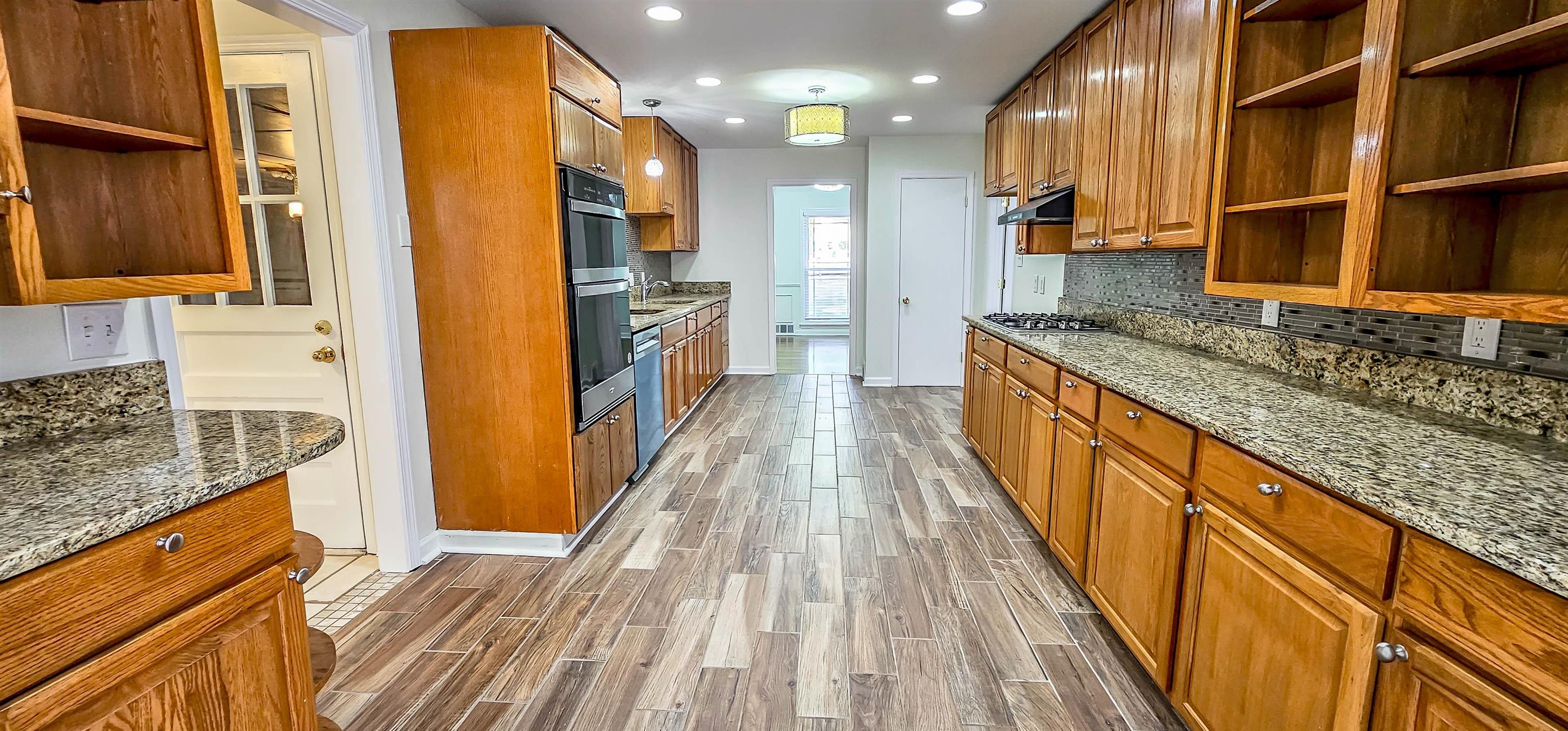 5639 Glade View Drive Memphis, TN 38120 - Photo 15 of 39 a kitchen with stainless steel appliances granite countertop a refrigerator a sink and a stove