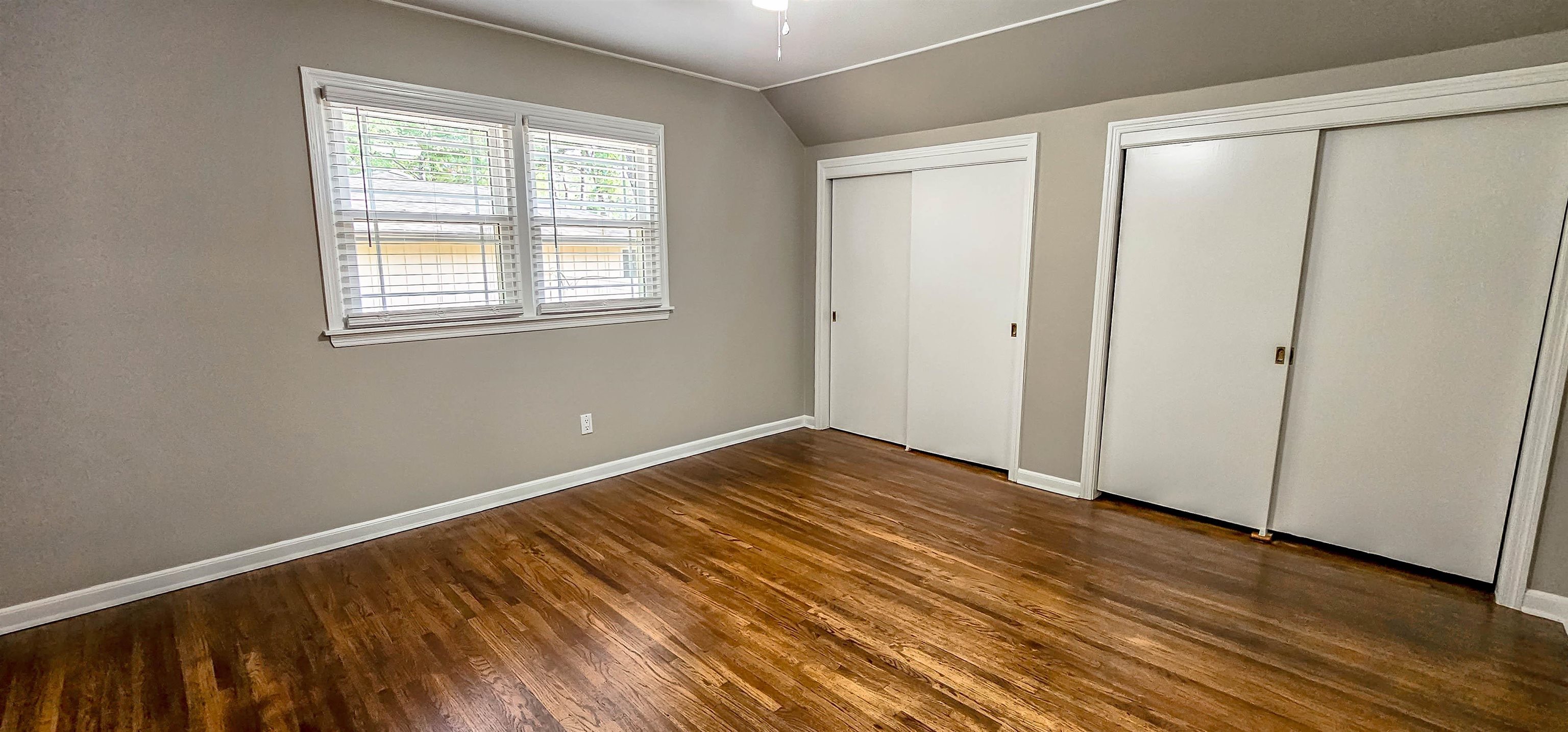 5639 Glade View Drive Memphis, TN 38120 - Photo 27 of 39 a view of an empty room with wooden floor and a window