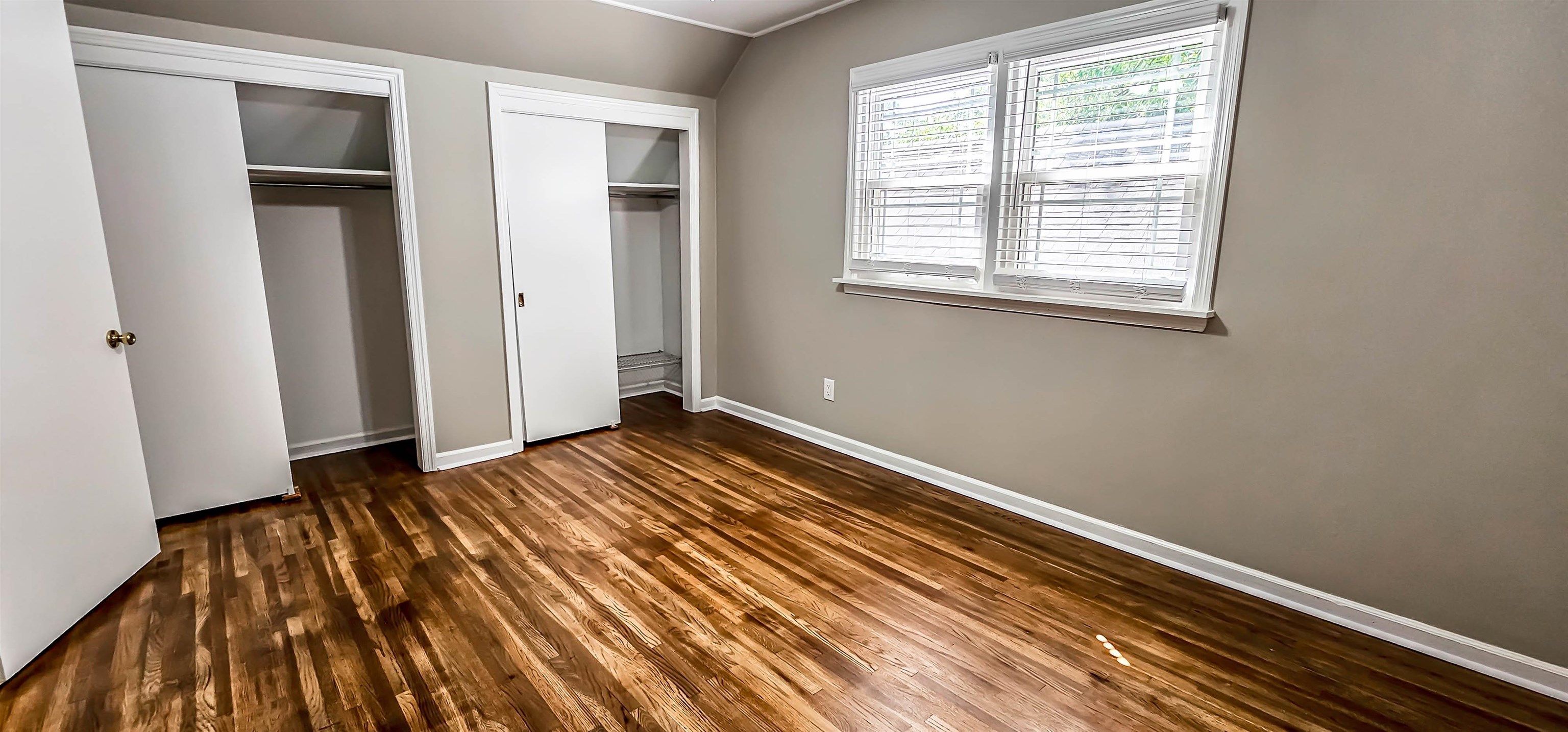 5639 Glade View Drive Memphis, TN 38120 - Photo 29 of 39 an empty room with wooden floor and windows