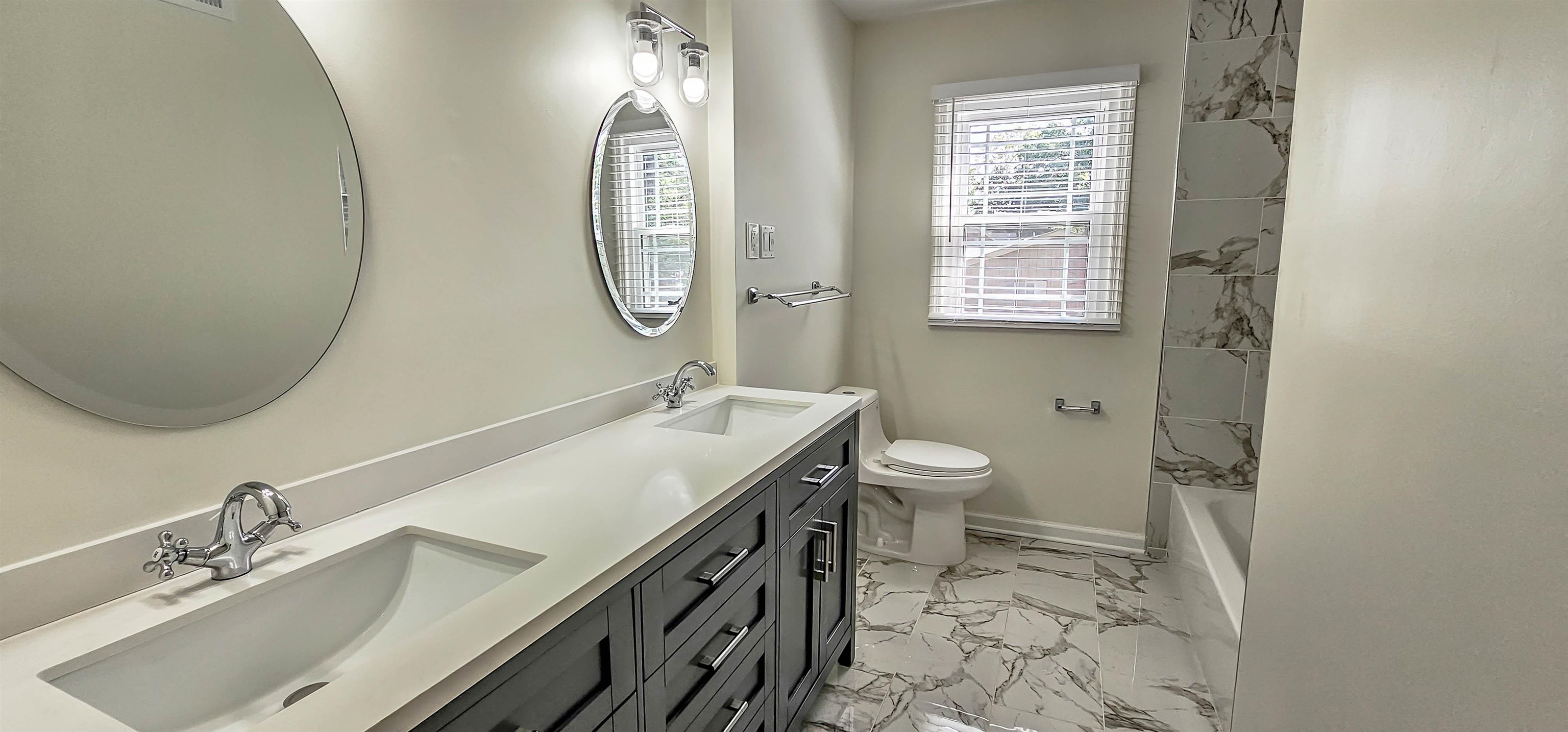 5639 Glade View Drive Memphis, TN 38120 - Photo 30 of 39 a bathroom with a granite countertop sink a toilet and a mirror