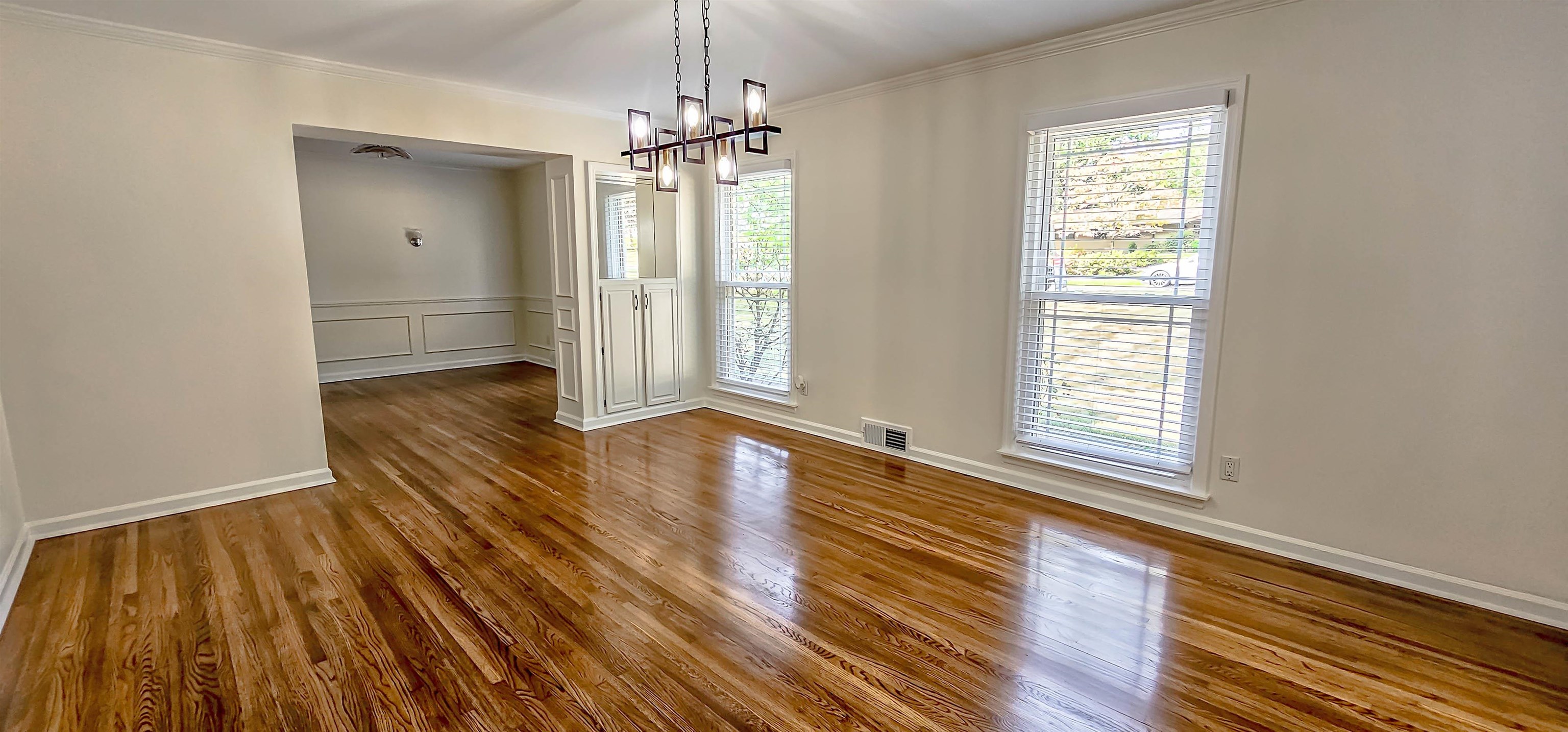 5639 Glade View Drive Memphis, TN 38120 - Photo 4 of 39 a view of an empty room with wooden floor and a window