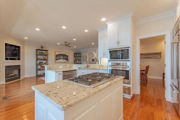 a kitchen with a stove a refrigerator and a stove top oven