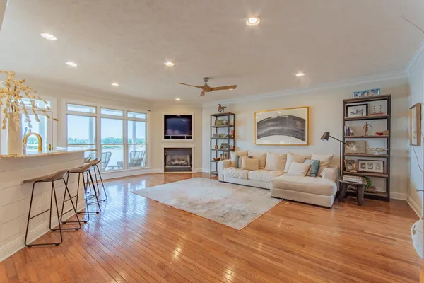 a living room with furniture and a wooden floor