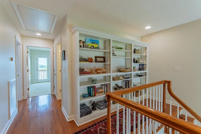 a view of a hallway with wooden floor and plants