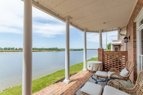 a view of a balcony with lake view and a floor to ceiling window