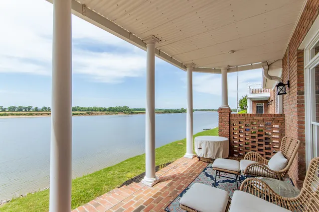 a view of a balcony with lake view and a floor to ceiling window