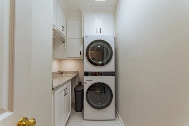 a utility room with sink dryer and washer