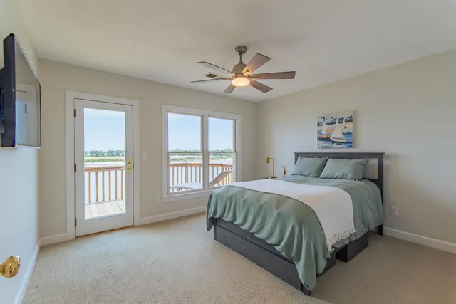 a bedroom with a bed next to a window