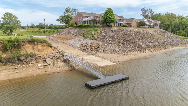 a view of a dry yard with wooden fence