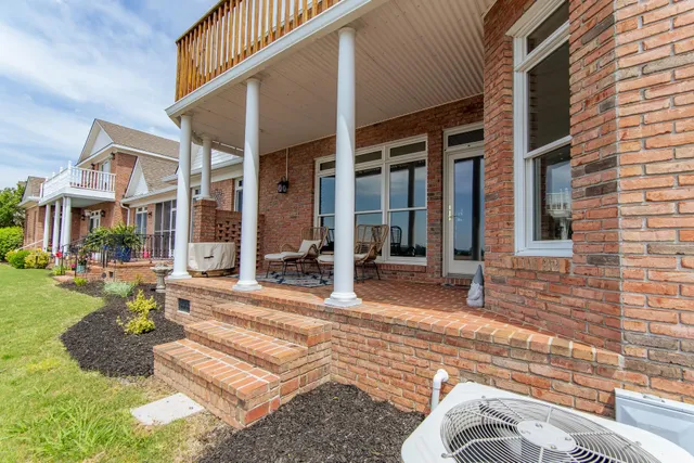 a view of a house with backyard porch and sitting area