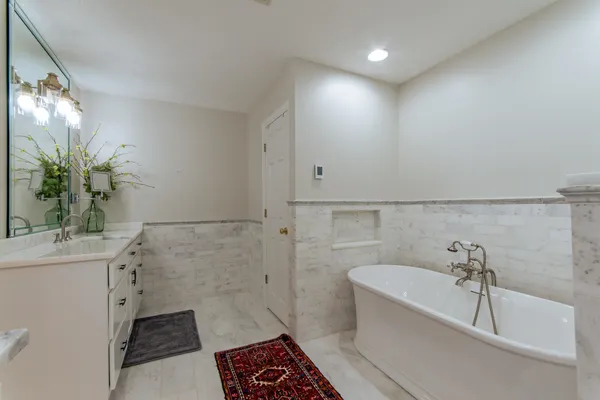a bathroom with a bathtub and sink