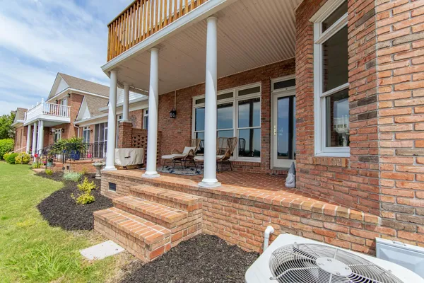 a view of a house with backyard porch and sitting area
