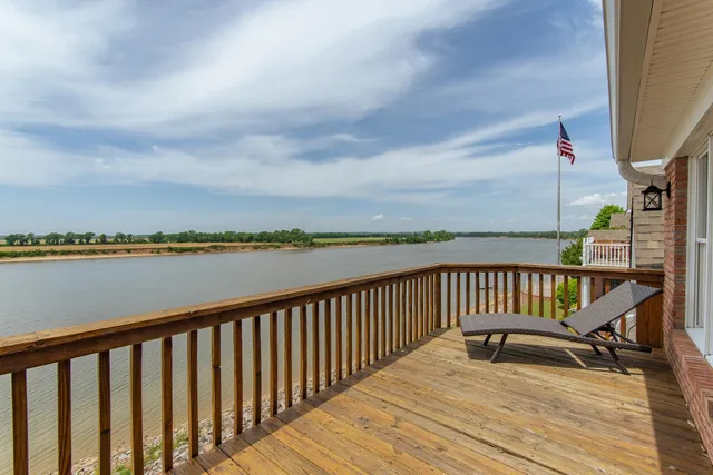 a balcony with wooden floor and fence
