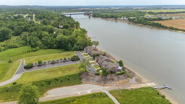 an aerial view of a house with a yard and lake view