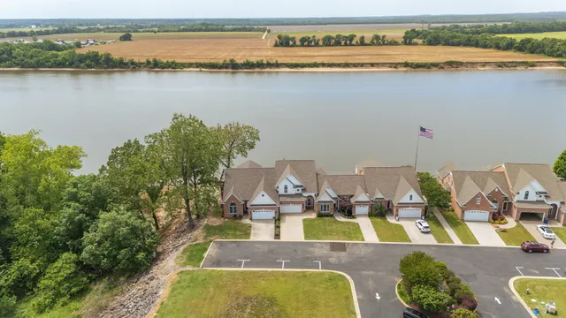 an aerial view of residential houses with outdoor space and seating