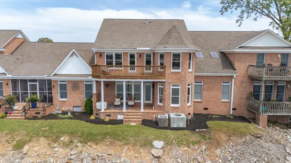 a view of a house with a yard and sitting area