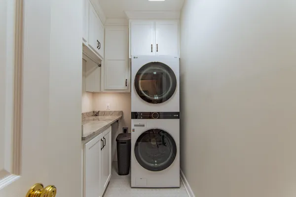 a utility room with sink dryer and washer