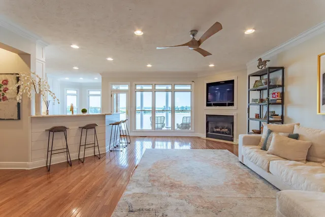 a living room with fireplace furniture and a large window