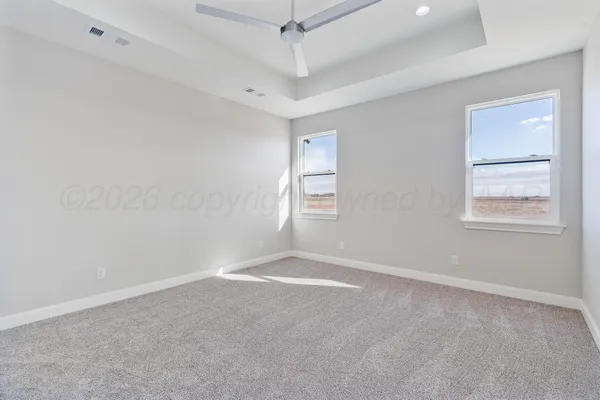 an empty room with windows and closet