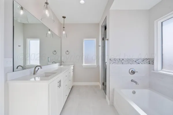 a bathroom with double vanity sinks and a mirror