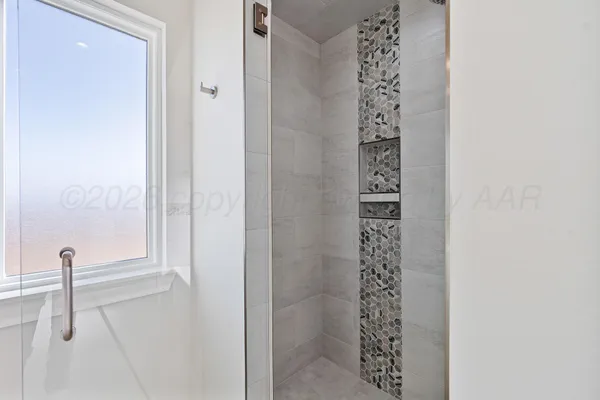 an empty room with a window and ceiling fan