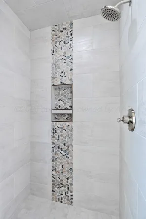 an empty room with a window and ceiling fan