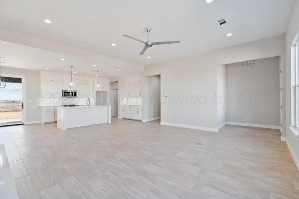 a view of a kitchen with a sink and a refrigerator