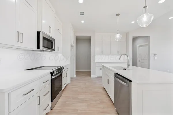 a kitchen with a sink stove and microwave
