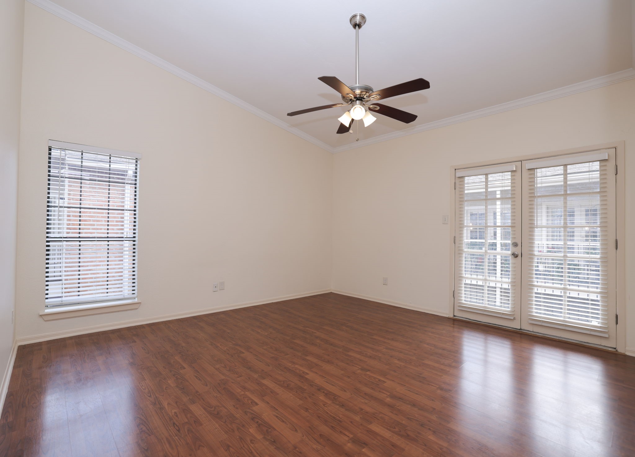 2001 Bering Drive, Unit 2F Houston, TX 77057 - Photo 12 of 32 an empty room with wooden floor fan and windows