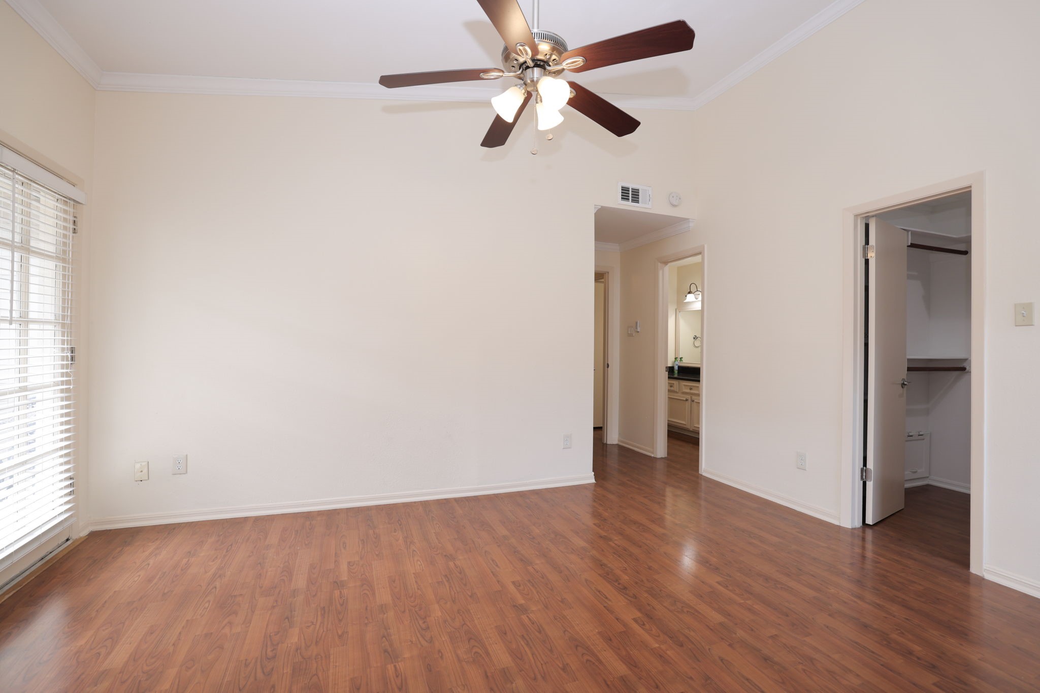 2001 Bering Drive, Unit 2F Houston, TX 77057 - Photo 13 of 32 an empty room with wooden floor chandelier fan and windows