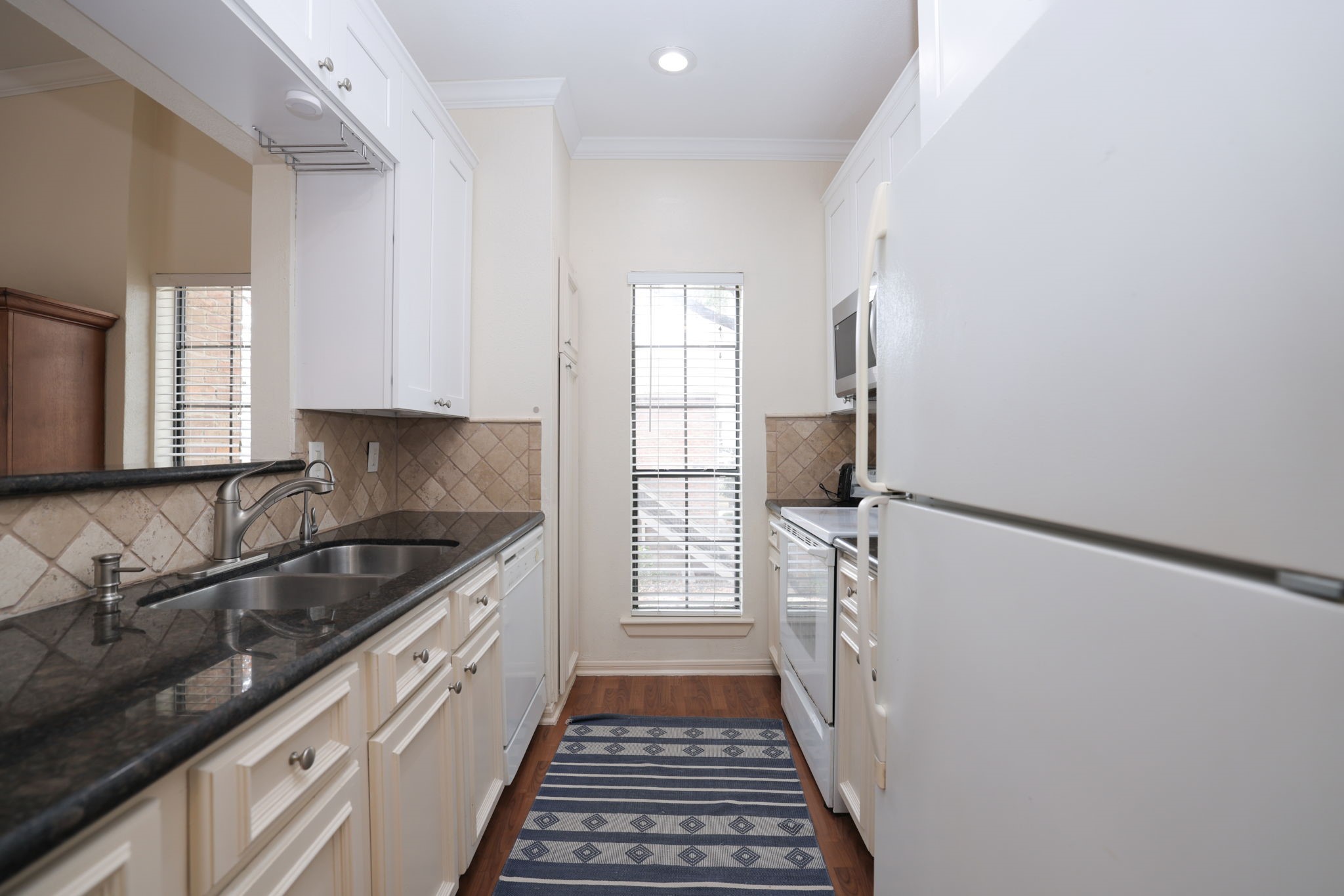 2001 Bering Drive, Unit 2F Houston, TX 77057 - Photo 7 of 32 a kitchen with granite countertop a sink and a stove top oven