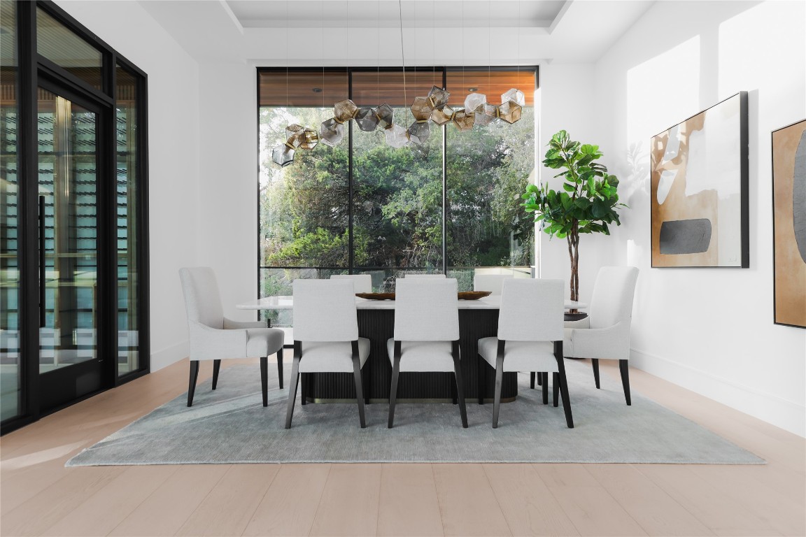 1003 The High Road Austin, TX 78746 - Photo 13 of 40 a dining room with furniture and a large window