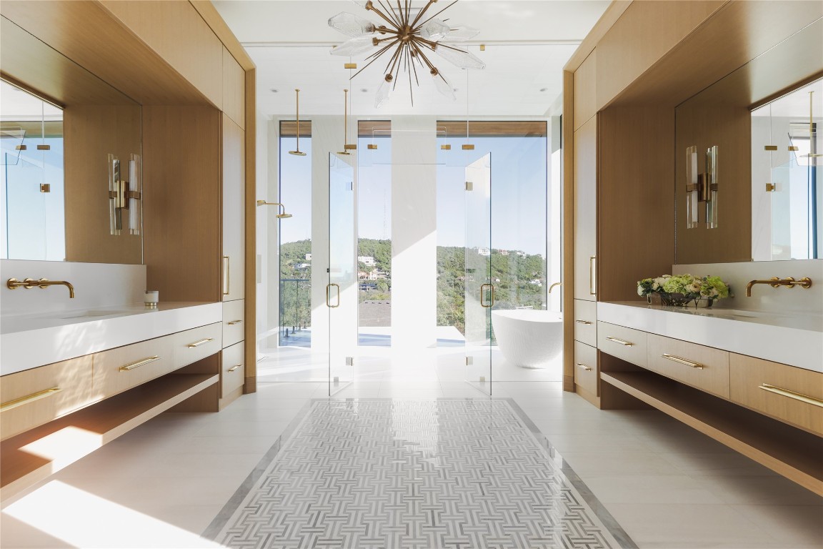 1003 The High Road Austin, TX 78746 - Photo 21 of 40 a bathroom with a double vanity sink and mirror