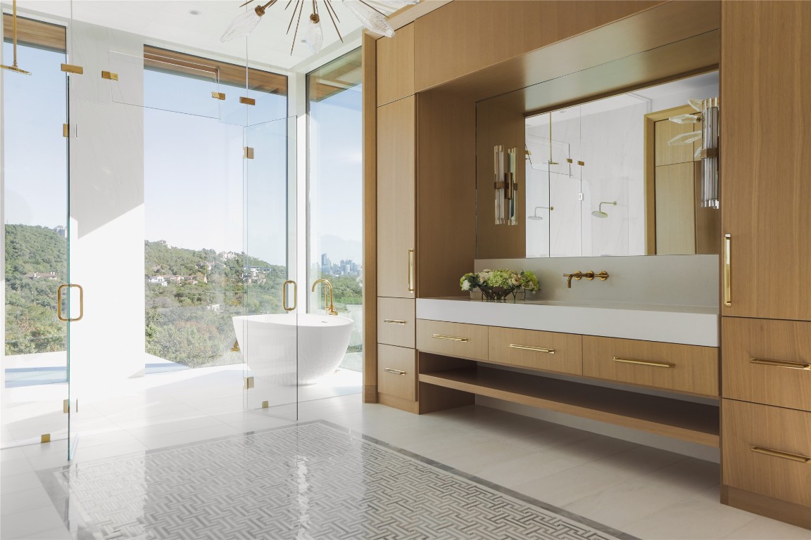 1003 The High Road Austin, TX 78746 - Photo 22 of 40 a bathroom with a bathtub and a shower