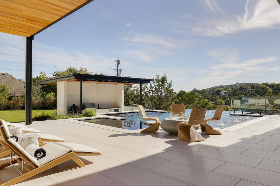 1003 The High Road Austin, TX 78746 - Photo 34 of 40 a view of a patio with a table and chairs and couches